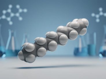 Close-up of a 15-linked peptide chain rendered as connected spheres above a blurred medical laboratory background in cool blue and white tones.